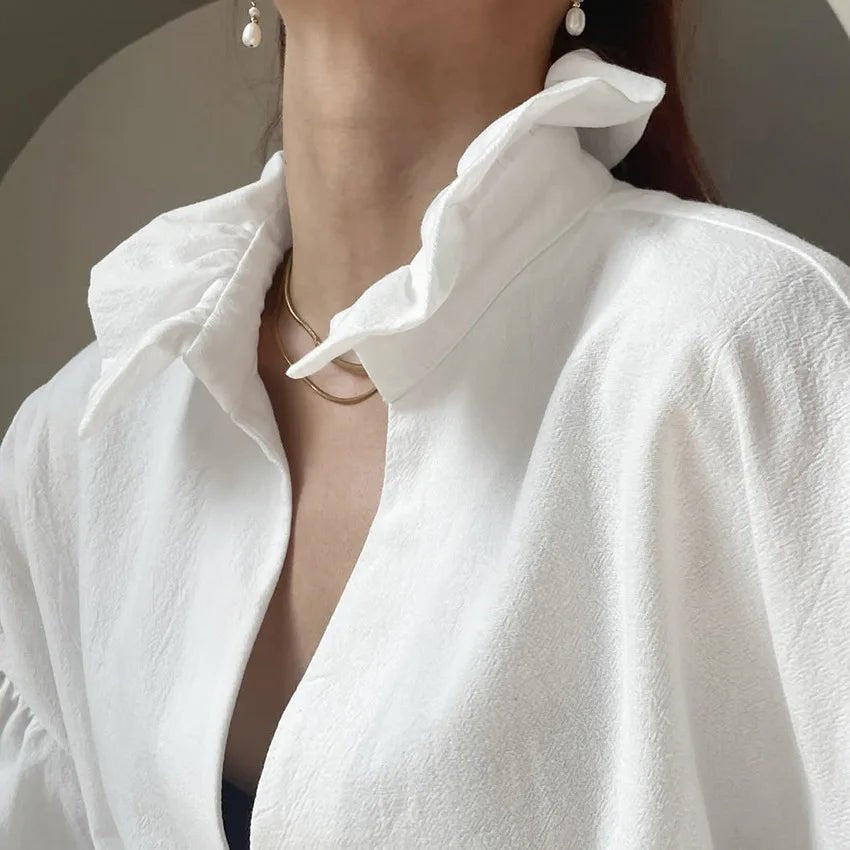 Blusa Lola a maniche lunghe a sbuffo con scollo a V
